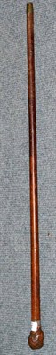 Lot 218 - A 19th century malacca walking cane with a carved bust of a gentleman