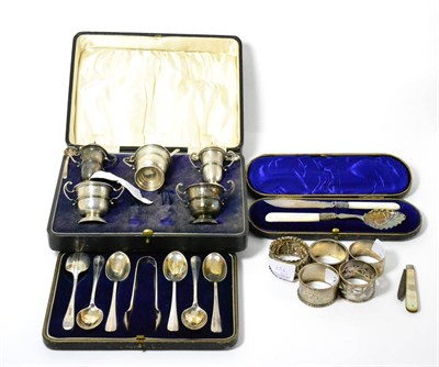 Lot 256 - A silver five piece cruet set, a set of six teaspoons, a napkin clip, five napkin rings and a cased