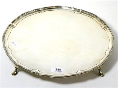 Lot 286 - A large silver salver by R & WS, London, 1925, raised on four hoof feet