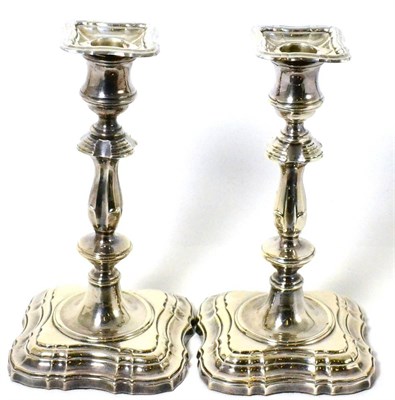 Lot 287 - A pair of George II style silver candlesticks by Vander Sheffield, 1965 (2)