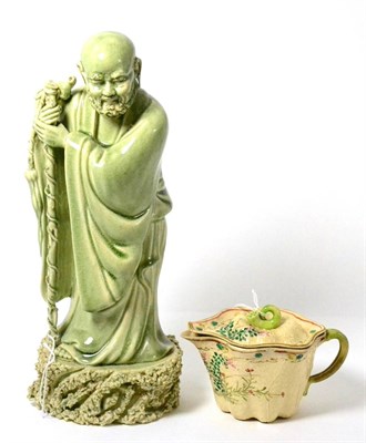 Lot 299 - A Chinese celadon glazed figure of an immortal with a ceramic gourd-form teapot (2)