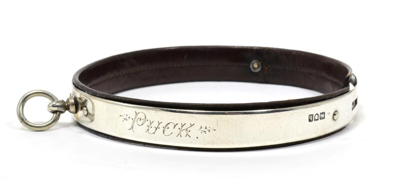 Lot 29 - An Edwardian Silver and Leather Dog Collar, London 1903, inscribed PUCK, 11cm diameter