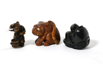 Lot 313 - A Japanese wood netsuke, 19th century, as a crouching figure peering into a brazier, signed,...