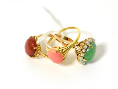 Lot 319 - A 9ct gold agate ring, an 18ct gold coral ring and a green stone and split pearl cluster ring,...