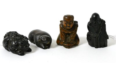 Lot 322 - A Japanese wood netsuke, 19th century, as a boy kneeling on a tortoise, 4.5cm; a similar...