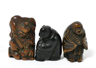 Lot 327 - A Japanese wood netsuke, 19th century, as Shoki, the demon queller standing over a demon,...