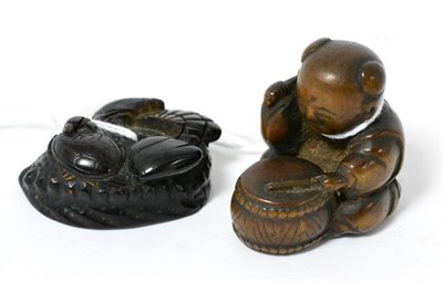 Lot 328 - A Japanese wood netsuke, 19th century, as a seated tiger with inlaid eyes, two character signature