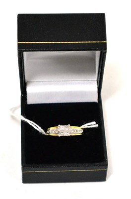 Lot 348 - An 18ct gold princess cut diamond four stone ring with diamond set shoulders