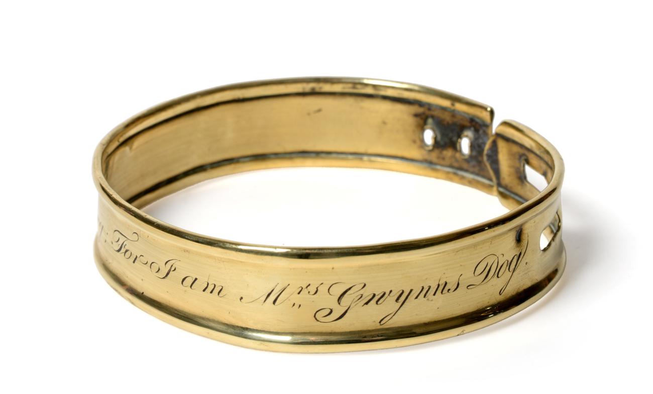 Lot 34 - A Brass Dog Collar, early 19th century, inscribed Steal me not but let me jog; For I am Mrs Gwynn's