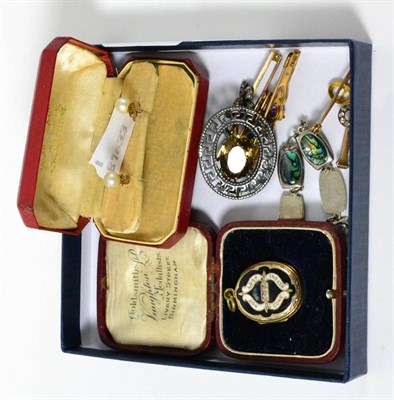 Lot 379 - Five dress brooches, one stamped '9CT', a gilt metal locket, a Scottish brooch and pearl...