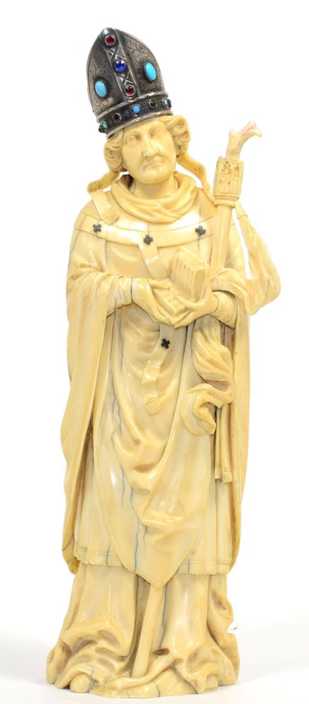 Lot 43 - A Dieppe Ivory Figure of a Bishop, late 19th century, the standing figure wearing a white metal...
