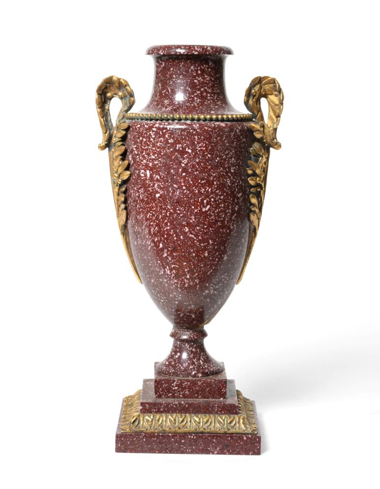 Lot 44 - A Gilt Metal Mounted Porphyry Urn Shaped Vase, 19th century, with leaf scroll handles, on a stepped