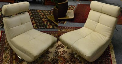 Lot 1022 - A pair of Italian leather and chrome swivel chairs