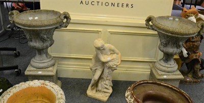 Lot 1024 - A pair of concrete twin handled urns and a garden ornament of a classical figure (3)