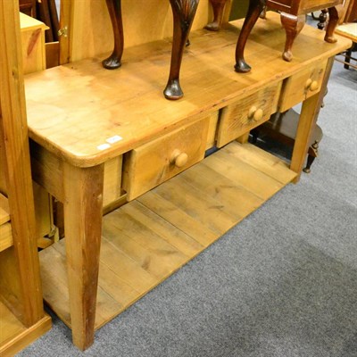 Lot 1049 - A pine farmhouse dresser base fitted with three drawers