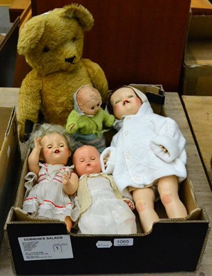 Lot 1065 - Four various vintage dolls and a yellow plush covered Teddy bear