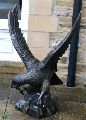 Lot 1097 - A large cast figure of an eagle atop rocky outcrop, late 20th century