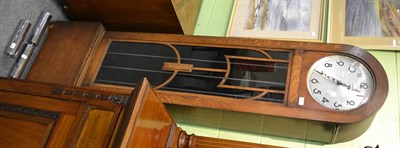 Lot 1113 - A 1920's/1930's oak longcase clock