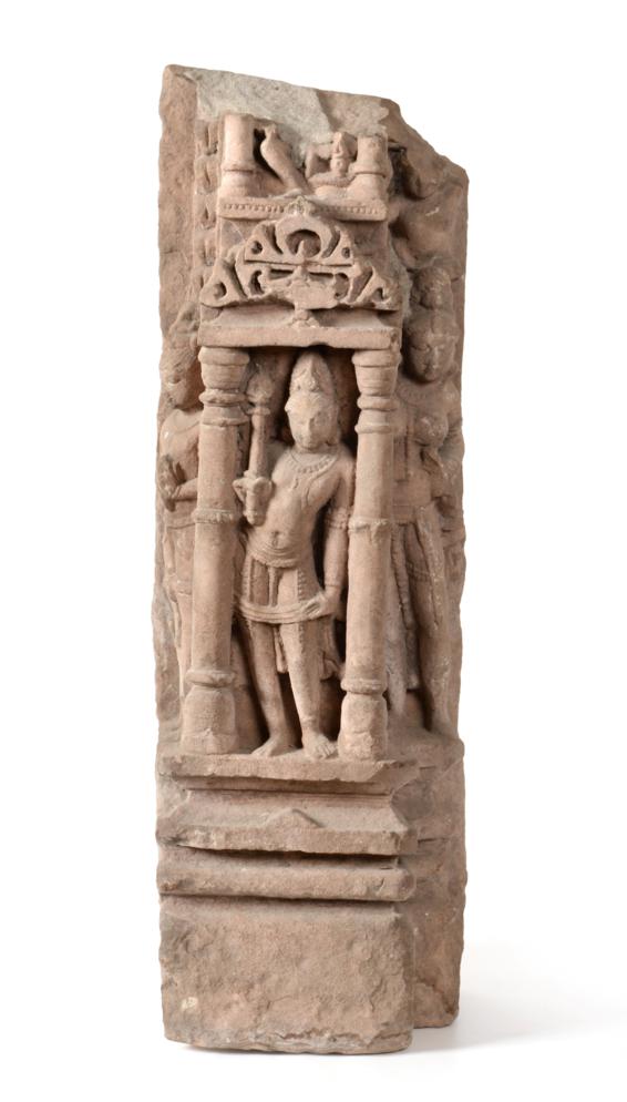 Lot 62 - An Indian Sandstone Architectural Panel, in 10th century style, carved with a  figure standing in a