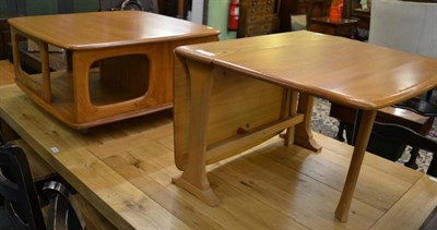 Lot 1143 - An Ercol Windsor elm wood coffee table, after a design by Lucian Ercolani, together with a matching