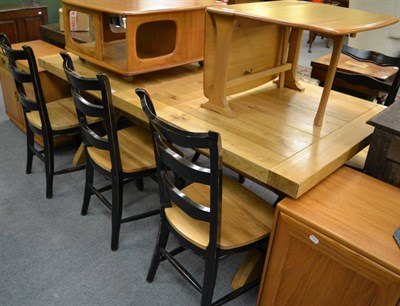 Lot 1144 - A light oak seven piece dining suite comprising of a table and six chairs