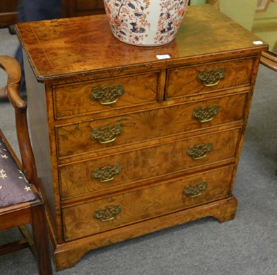 Lot 1152 - A reproduction burr elm chest of drawers