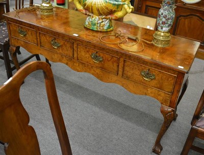 Lot 1153 - A reproduction burr elm four drawer side table