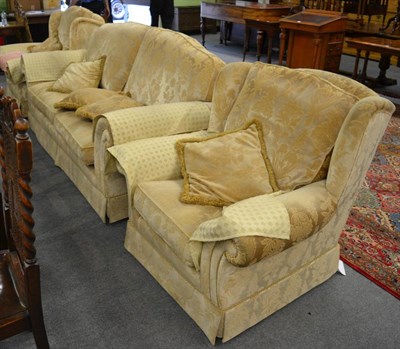 Lot 1170 - A modern three piece suite upholstered in gold coloured fabric