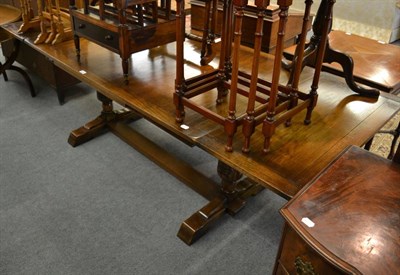 Lot 1187 - A reproduction extending oak dining table