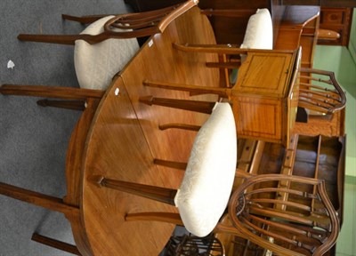 Lot 1192 - A late Georgian mahogany D-end dining table with fly legs, additional leaf and brass clips,...