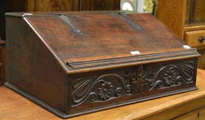 Lot 1196 - An English oak desk box, carved 1674 and initialled MT, the hinged lid with metal hinges...