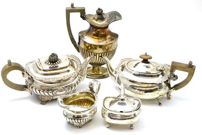 Lot 33 - A group of silver including two teapots, a hot water pot, cream jug and mustard pot (5)