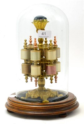 Lot 41 - A gilt brass bobbin stand in period style on a wooden base with glass dome