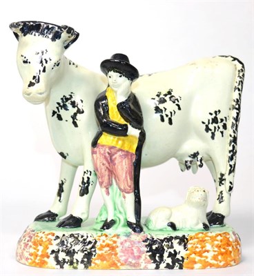 Lot 78 - A Yorkshire Prattware Cow Group, circa 1800, modelled as a cowherd standing beside a cow, a calf at