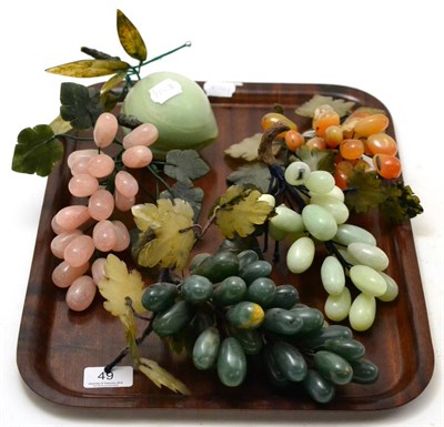 Lot 49 - Chinese hardstone fruit comprising four bunches of grapes and a peach