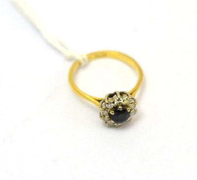 Lot 78 - A Boodle & Dunthorne 18ct gold sapphire and diamond flower head cluster ring