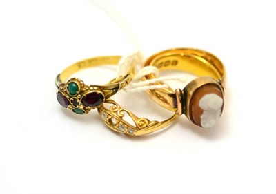 Lot 87 - A 22ct gold band ring, 18ct gold cameo ring, 18ct gold ring, and 18ct gold multi stone ring (4)