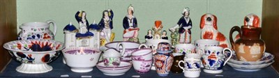 Lot 125 - A group of 19th century ceramics including Staffordshire figures, seated spaniels, lustre...