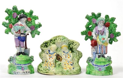 Lot 89 - A Pair of Salt Pearlware Figures of Gardeners, circa 1810, he with a basket of flowers and a spade
