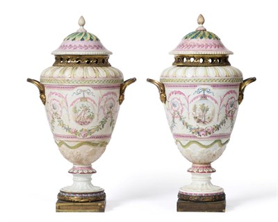 Lot 97 - A Pair of Buen Retiro Porcelain Pot Pourri Vases and Covers, circa 1790, painted with neo-classical