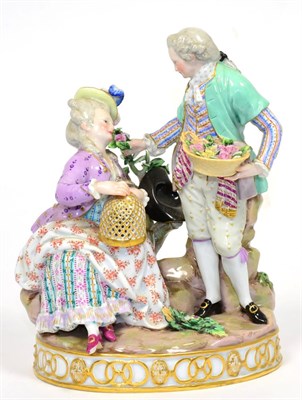 Lot 98 - A Meissen Porcelain Figure Group of Lovers, circa 1880, he standing holding a basket of...