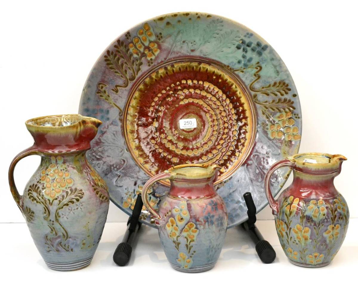 Lot 250 - John Calver studio pottery charger and three matching jugs (4)