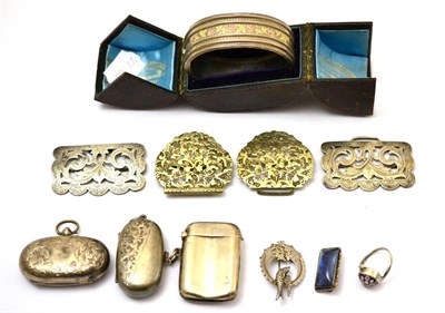 Lot 302 - A group of silver including two sovereign cases, two belt buckles, a vesta, silver bangle, brooches