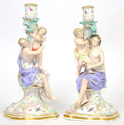 Lot 104 - A Pair of Meissen Porcelain Candlesticks, circa 1900, each modelled as a classical maiden holding a