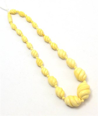 Lot 321 - A 1930's whirl carved ivory bead necklace