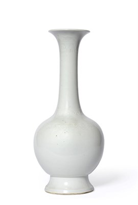 Lot 110 - A Chinese Porcelain Bottle Vase, Xuande reign mark, the tall slender neck carved with bands of...