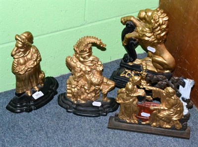 Lot 365 - Four Victorian painted cast iron door stops including a Lion Passant, Punch & Judy, etc