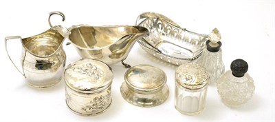 Lot 423 - A tray of silver items comprising, a silver sauce boat, a Georgian cream jug, a pierced basket,...