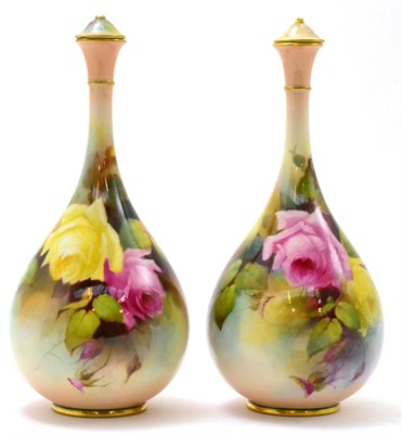 Lot 470 - A pair of Royal Worcester floral decorated vases and covers (a.f.), by Jarmin