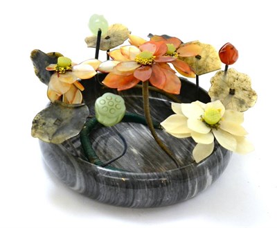 Lot 493 - Chinese hardstone floral group in a bowl